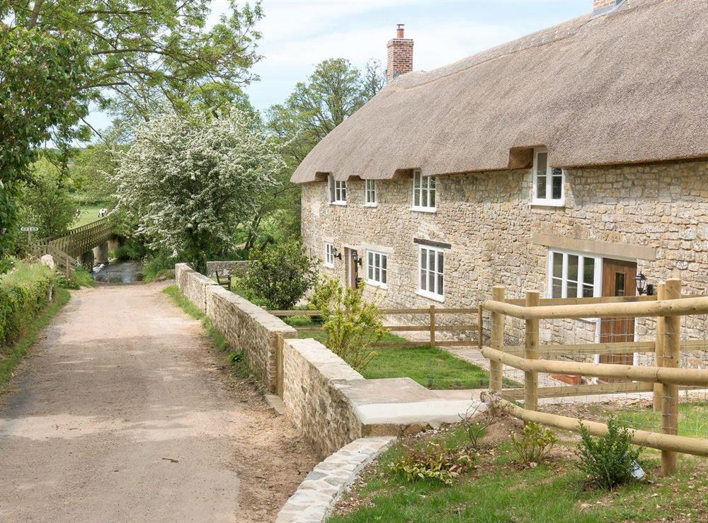 Exterior, road leading to ford, and footbridge at The Farmhouse at Higher Westwater Farm in Axminster, Devon