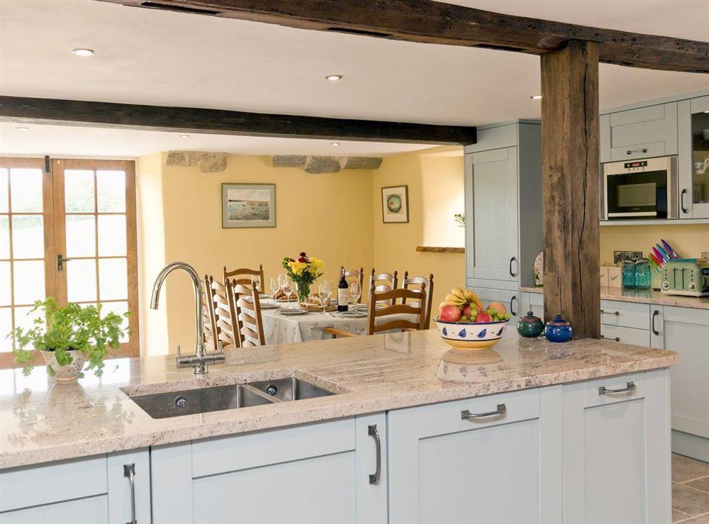 Fantastic kitchen/ diner with beamed ceiling at The Farmhouse at Higher Westwater Farm in Axminster, Devon
