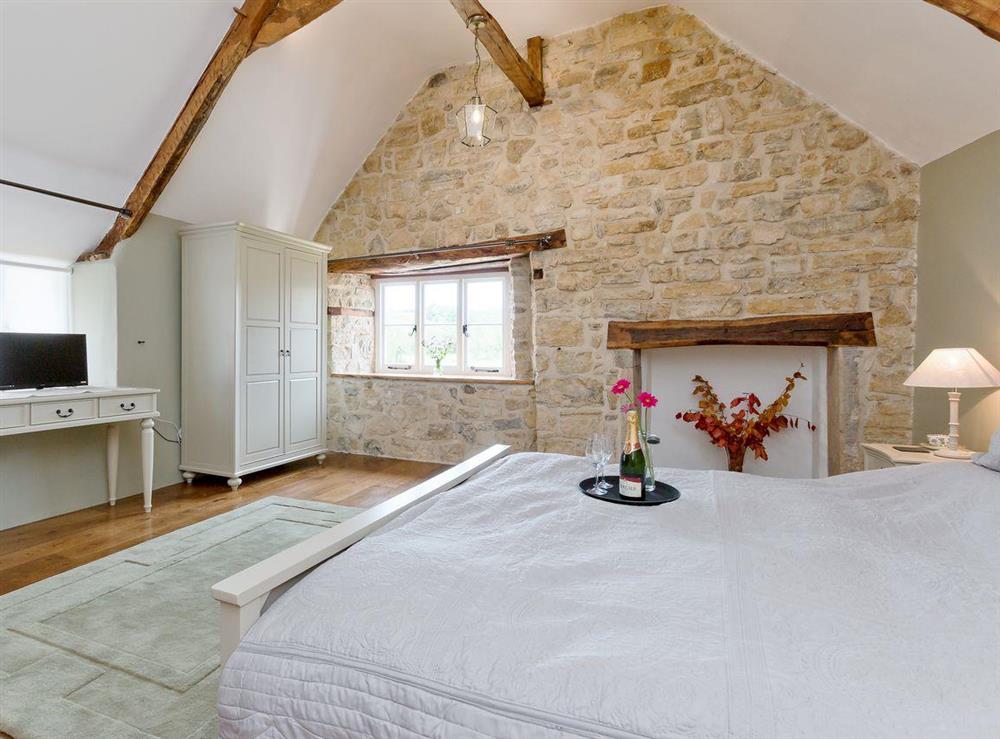 Large double bedroom with high, sloping ceilings at The Farmhouse at Higher Westwater Farm in Axminster, Devon