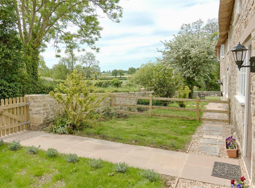 Pretty garden and views to the surrounding countryside at The Farmhouse at Higher Westwater Farm in Axminster, Devon