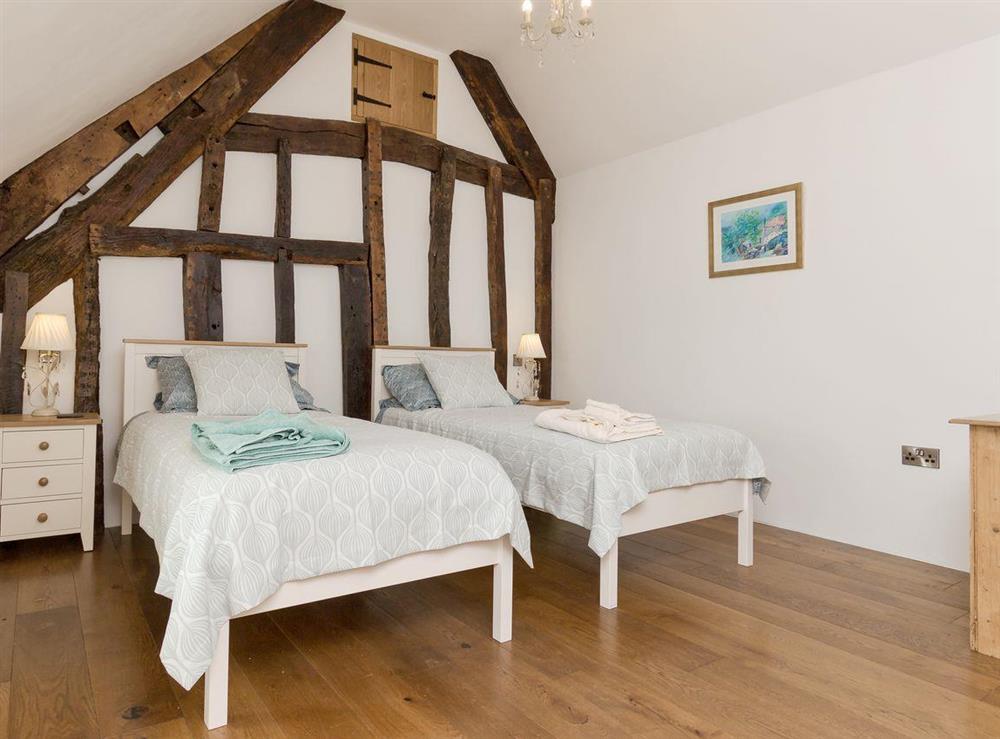 Pretty twin bedroom at The Farmhouse at Higher Westwater Farm in Axminster, Devon