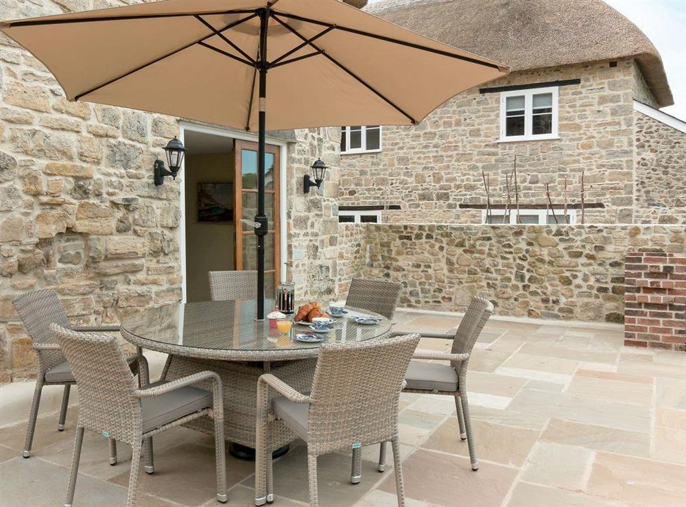 Seating out area on the patio at The Farmhouse at Higher Westwater Farm in Axminster, Devon