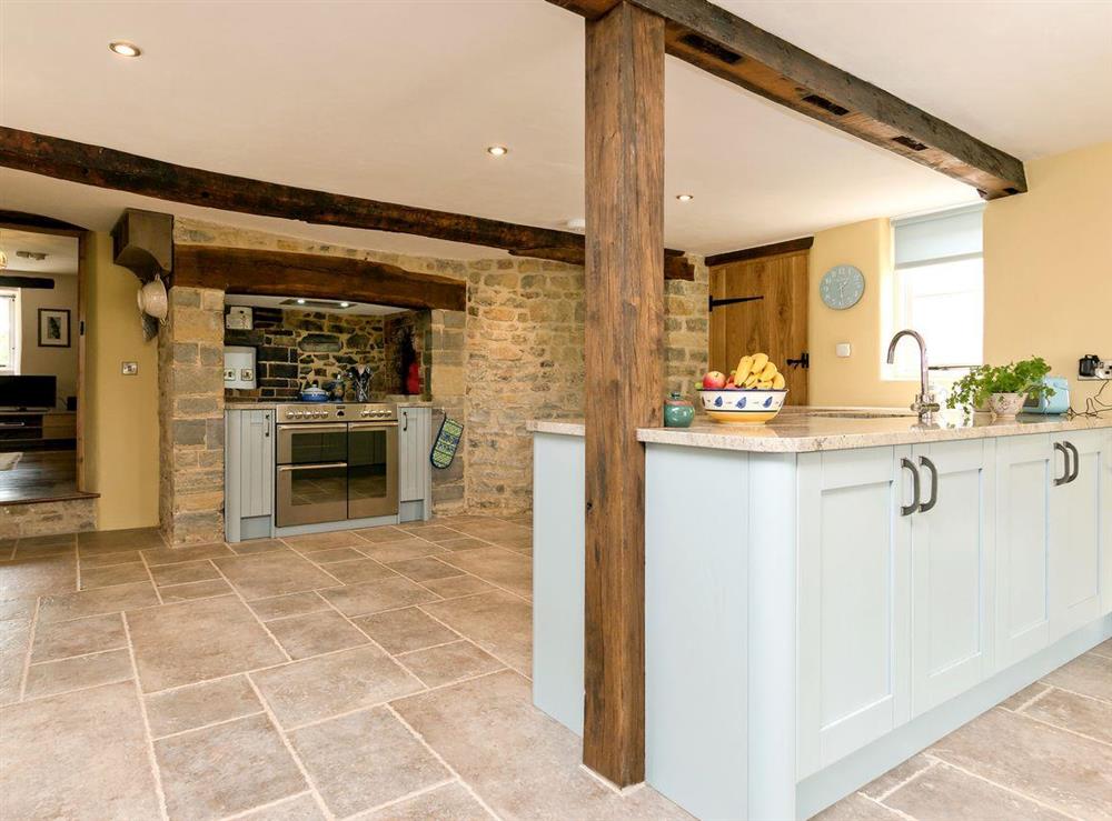 Well-equipped, beamed kitchen/dining room with electric range (for cooking) at The Farmhouse at Higher Westwater Farm in Axminster, Devon
