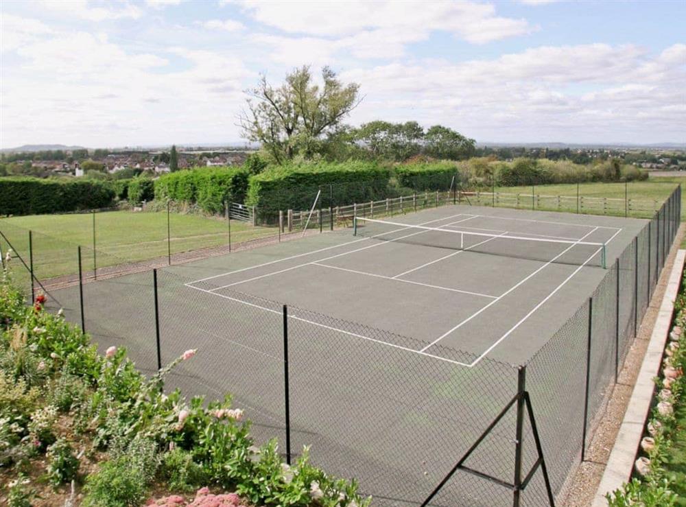 Tennis court at The Farmhouse in Cheltenham, Glos., Gloucestershire