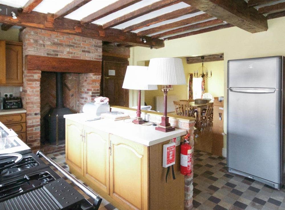 Good-sized kitchen with wood-burner at The Farmhouse in Kirk Langley, near Derby, Derbyshire