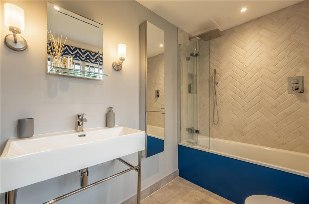 En-suite bathroom to Carr with bath, overhead rainfall shower and separate hand-held shower head at The Farmhouse,  Nether Hall Estate, Pakenham