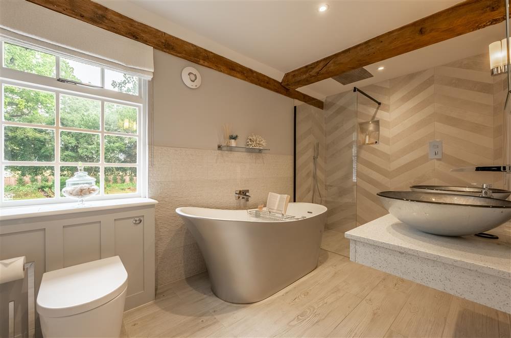 En-suite bathroom to Purnell with feature slipper bath, large walk-in shower and twin wash basins at The Farmhouse,  Nether Hall Estate, Pakenham