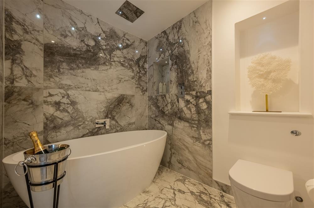 En-suite bathroom to The Laies with a feature, freestanding bath at The Farmhouse,  Nether Hall Estate, Pakenham