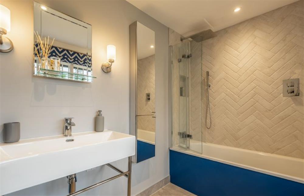 En-suite bathroom with bath with rainfall shower over at The Farmhouse, Nether Hall Estate, Pakenham