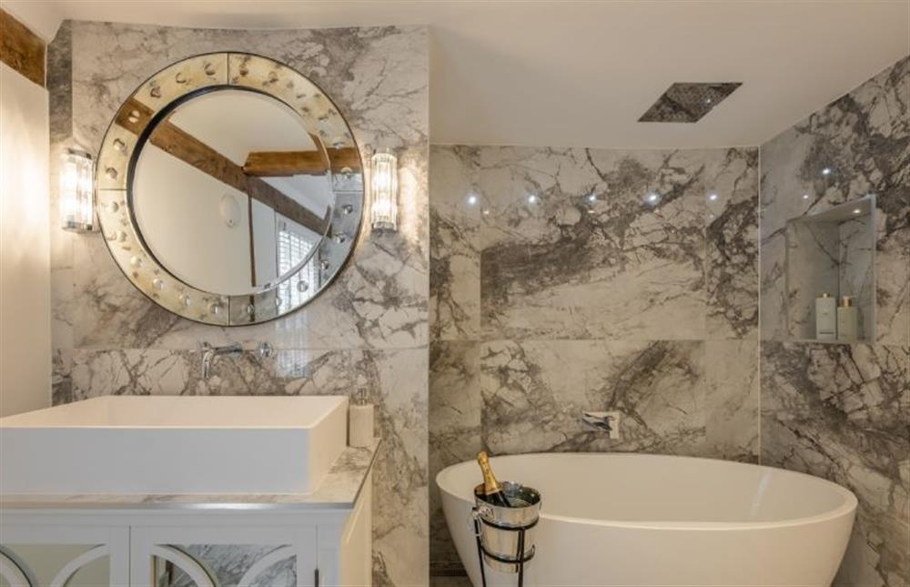 En-suite bathroom with beautiful marble walls at The Farmhouse, Nether Hall Estate, Pakenham