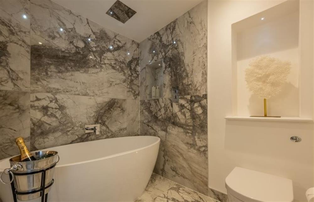 En-suite bathroom with feature, free-standing bath at The Farmhouse, Nether Hall Estate, Pakenham