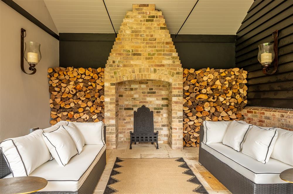 Fabulous undercover outdoor walk-way with open fire and more seating at The Farmhouse,  Nether Hall Estate, Pakenham