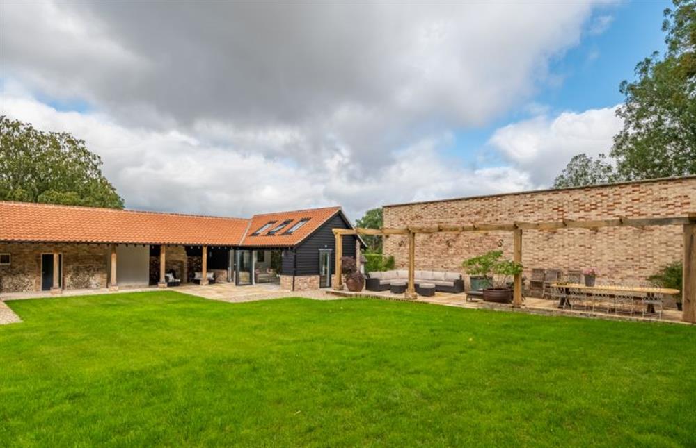 Large gardens overlooking the Vinehouse pergola and patio at The Farmhouse, Nether Hall Estate, Pakenham