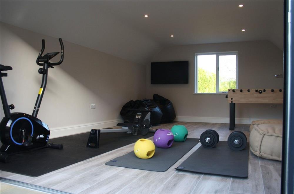 The Pit Stop - Activities room with gym equipment and table football at The Farmhouse,  Nether Hall Estate, Pakenham
