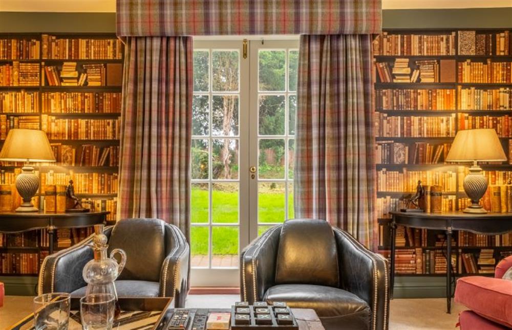 The snug with comfortable seating for a relaxing night in at The Farmhouse, Nether Hall Estate, Pakenham