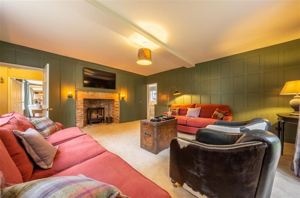 The Snug with electric wood burning stove and 55 inch Smart television at The Farmhouse,  Nether Hall Estate, Pakenham