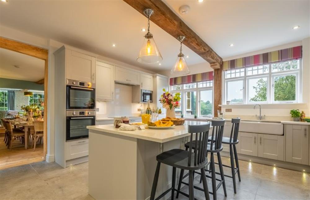 Well-equipped kitchen with breakfast bar at The Farmhouse, Nether Hall Estate, Pakenham