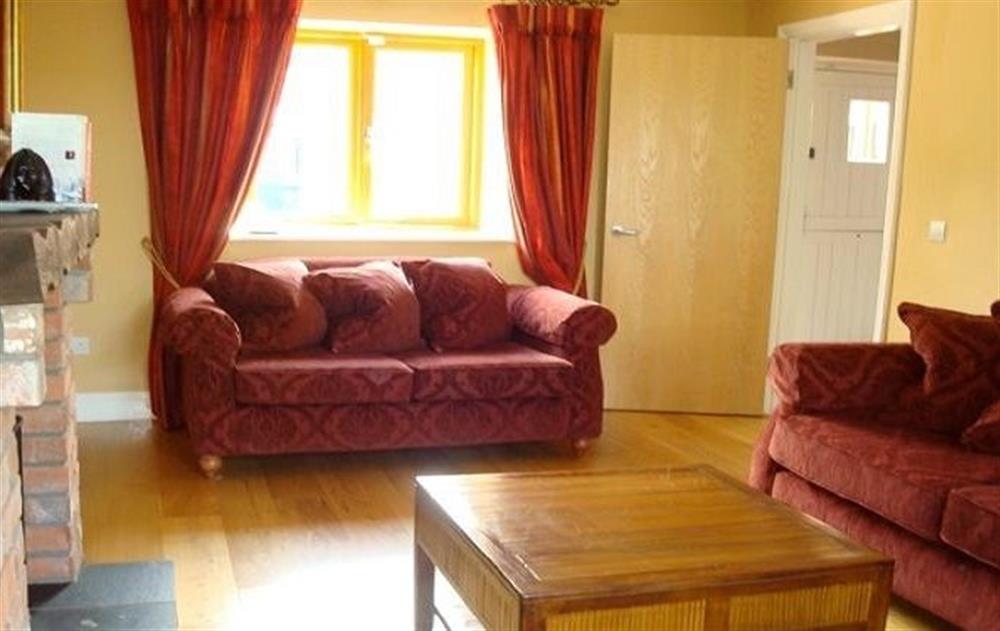 Ground floor:  Sitting room with oak floors and multi-fuel stove at The Forge, Navan