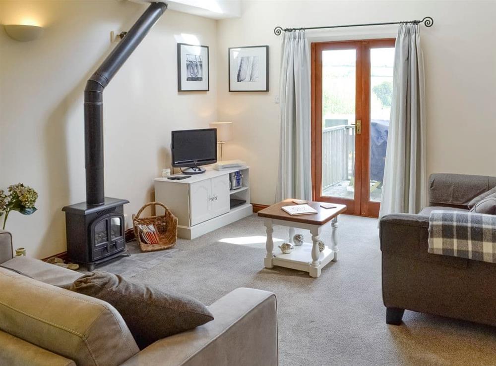 Light and airy living area with double doors to balcony at The Forge in Thorncombe, near Broadwindsor, Dorset