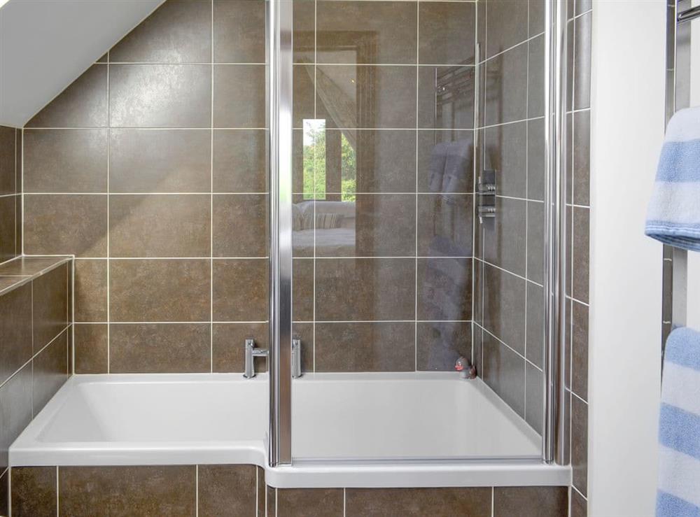 Modern bathroom with shower over bath at The Forge in Thorncombe, near Broadwindsor, Dorset