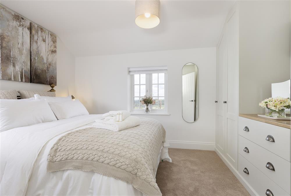 First floor: Bedroom one with a 5ft king-size bed, sumptuous furnishings and countryside views at The Gap, Blockley