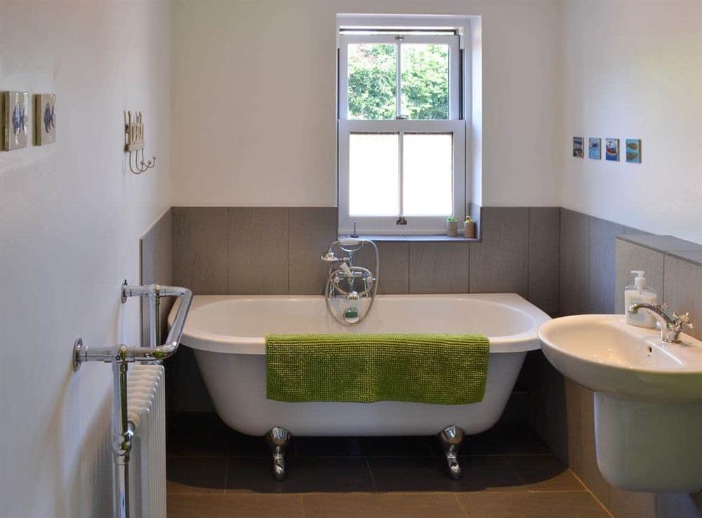 Ground floor bathroom with freestanding bath and walk-in shower at The Gap in Boulmer, near Alnwick, Northumberland