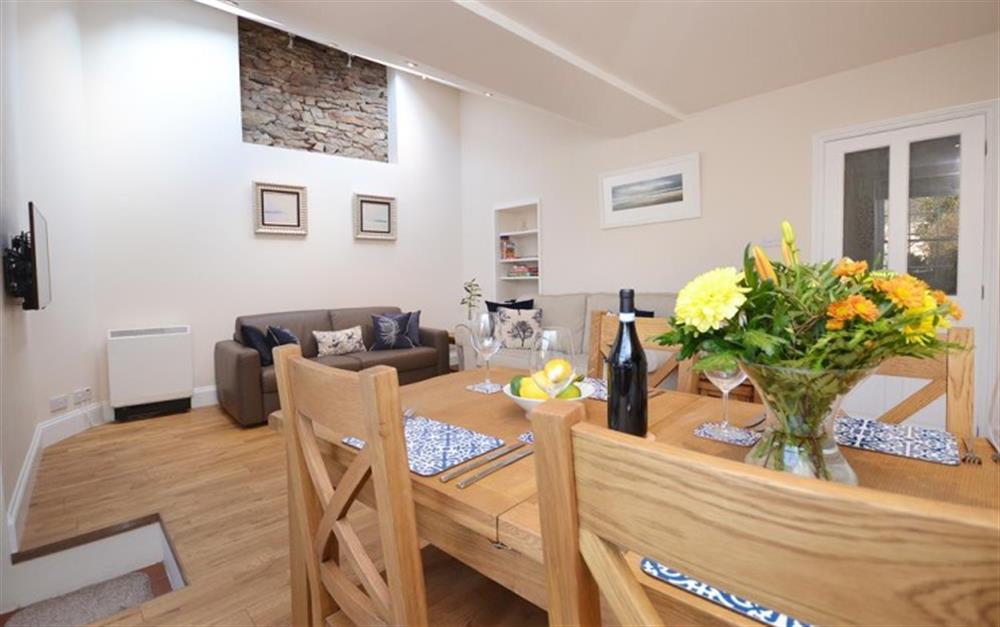 The living and dining area, with exposed stone wall.  at The Garden Annexe in Totnes