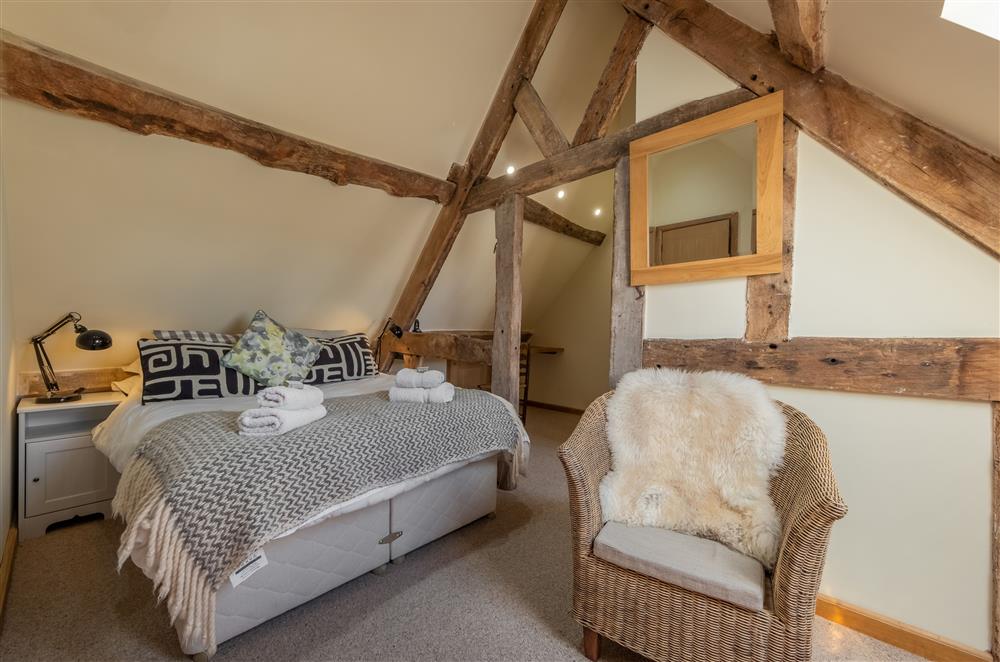 Bedroom one, with exposed timbers and en-suite shower room at The Garden Barn, Peterchurch