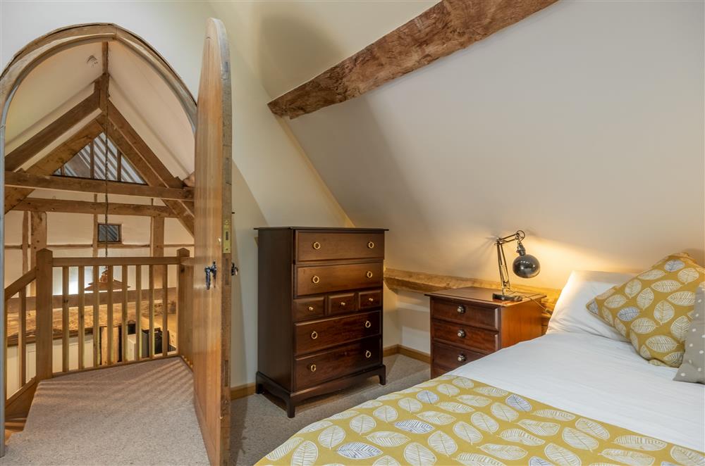 Bedroom two with exposed timbers and 4’6 double bed at The Garden Barn, Peterchurch