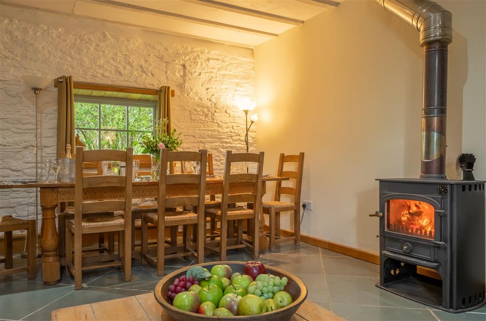 Dining area with seating for eight guests at The Garden Barn, Peterchurch