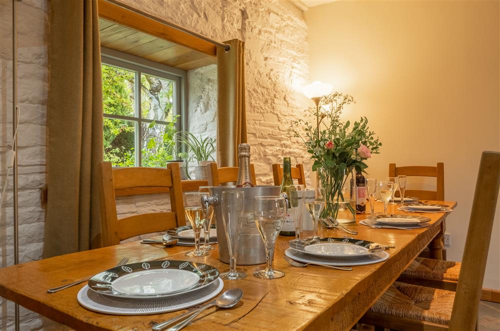 Dining area with view out to the pretty gardens at The Garden Barn, Peterchurch