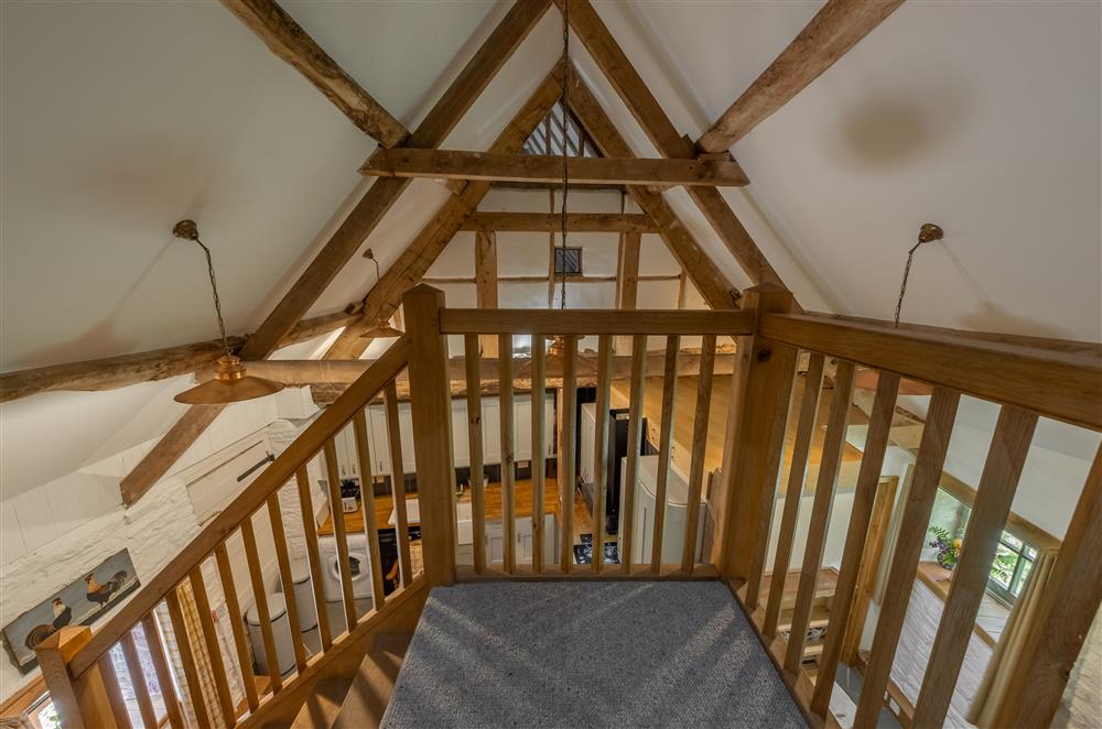 Gallery staircase looking down to ground floor living area at The Garden Barn, Peterchurch