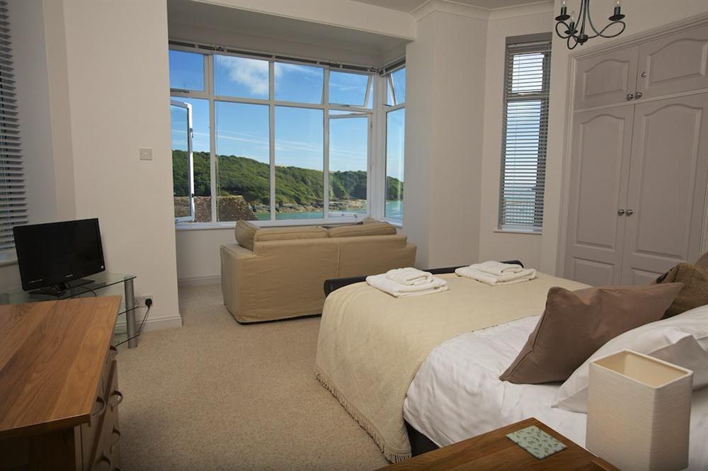 Master bedroom suite with sofa and stunning views at The Garden House (Woodside) in , Salcombe
