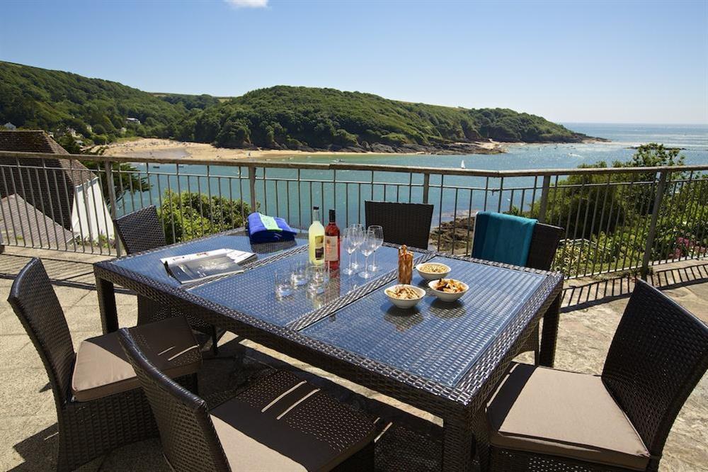 Spacious terrace with tables, chairs and lovely views towards Mill Bay at The Garden House (Woodside) in , Salcombe