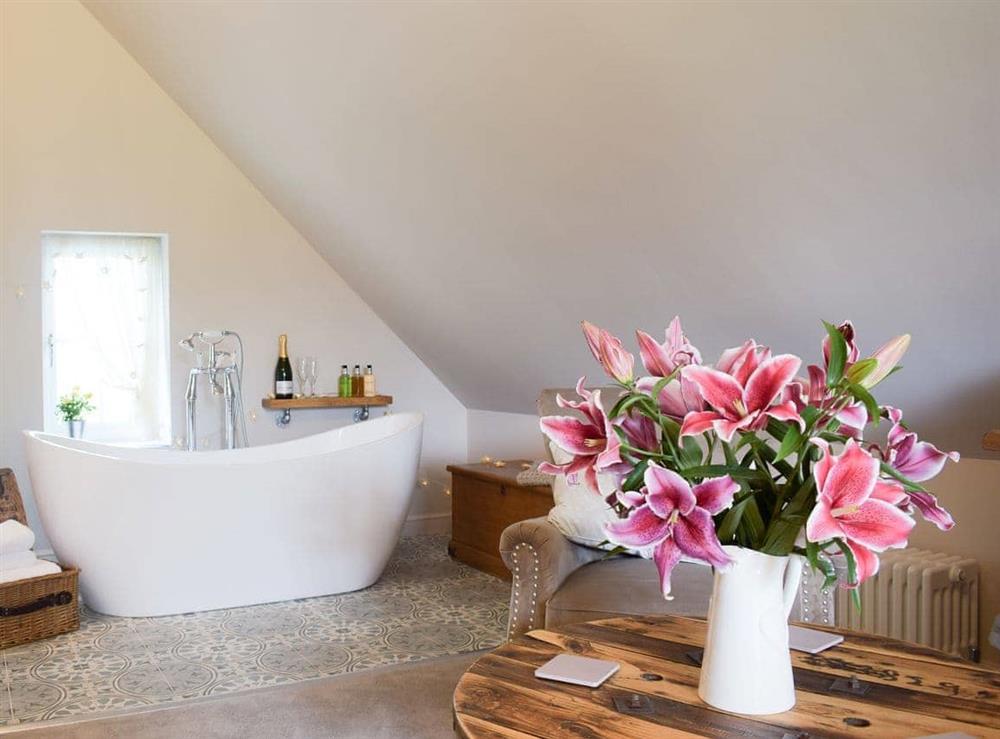 Inviting standalone bath in the bedroom at The Garden Retreat in Marbury, near Whitchurch, Hampshire