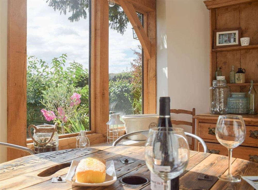 Rustic dining table with garden view at The Garden Retreat in Marbury, near Whitchurch, Hampshire
