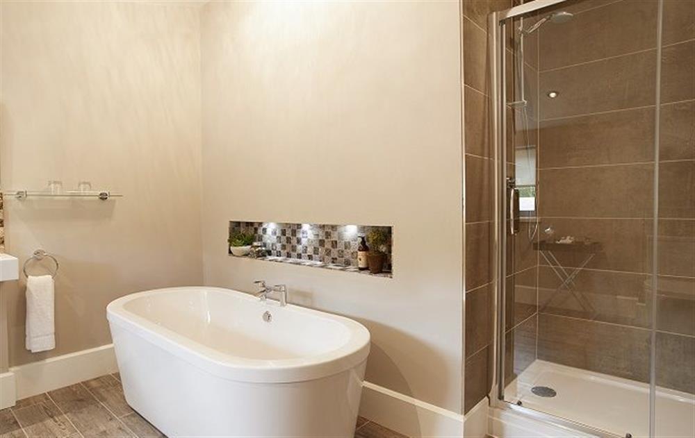 En-suite bathroom with separate shower at The Gardeners Bothy, Weston Park