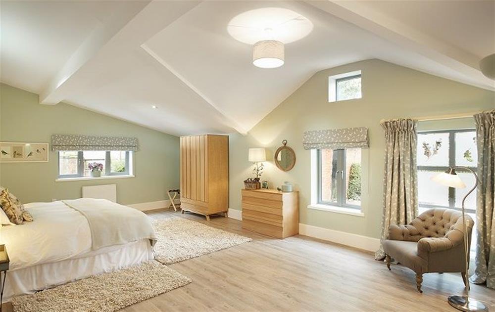 Spacious bedroom with 6’ double bed at The Gardeners Bothy, Weston Park