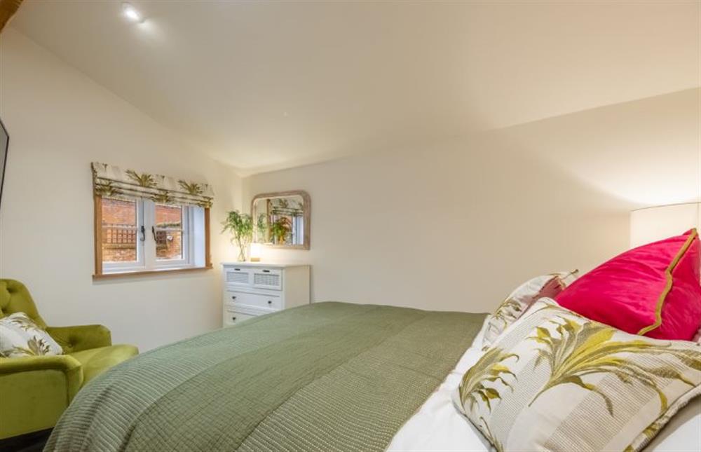 Ground floor: Bedroom two with king-size bed at The Gardeners Cottage, Earsham near Bungay