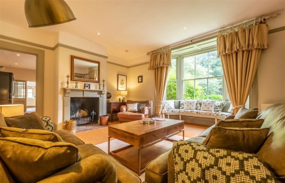 A beautifully presented drawing room that overlooks the garden at The Gardens, Burnham Market near Kings Lynn