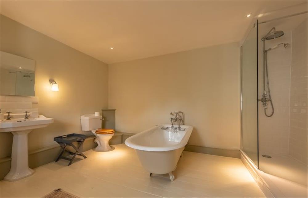 Bathroom one with free standing bath and shower cubicle at The Gardens, Burnham Market near Kings Lynn