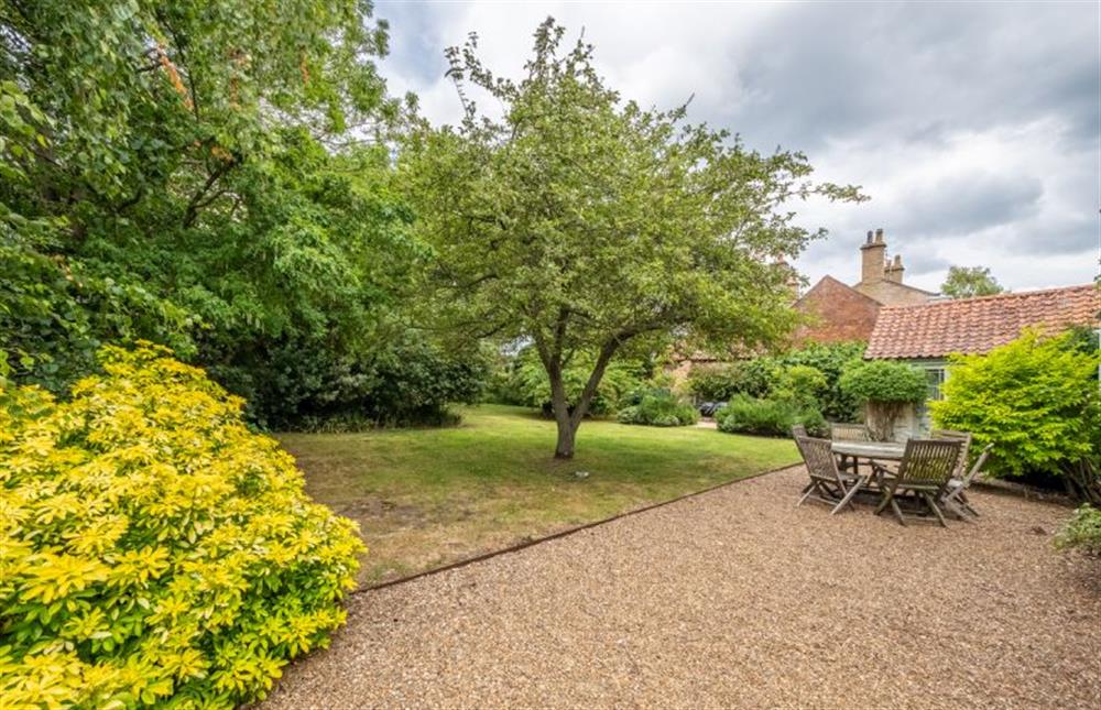 The garden is large and spacious with a shingled dining area at The Gardens, Burnham Market near Kings Lynn