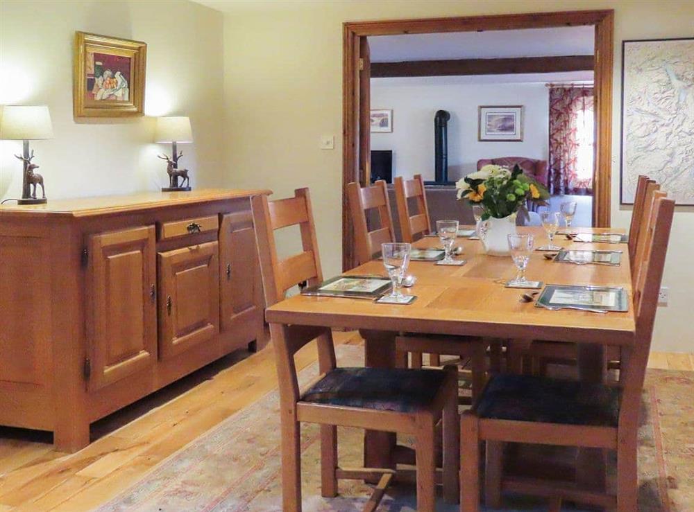 Stylish dining room with wooden floor at The Garth in Penrith, Cumbria