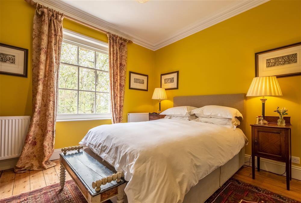 Bedroom one with a 5’ king-size bed and parkland views at The Gate House, Aylsham near Norwich