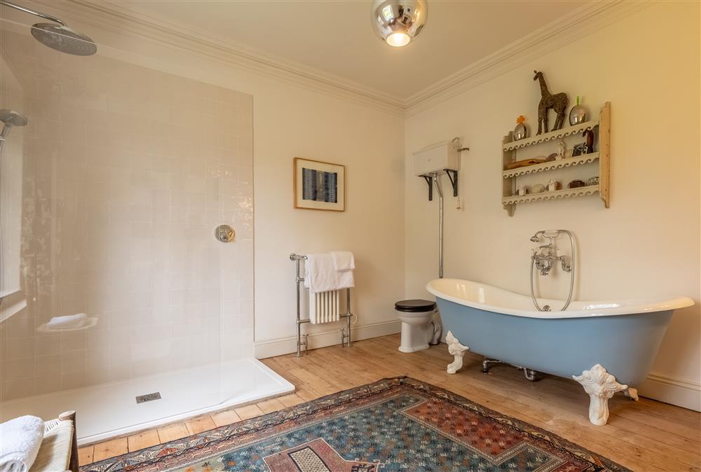 En-suite with cast iron bath, walk-in shower, wash basin and WC at The Gate House, Aylsham near Norwich