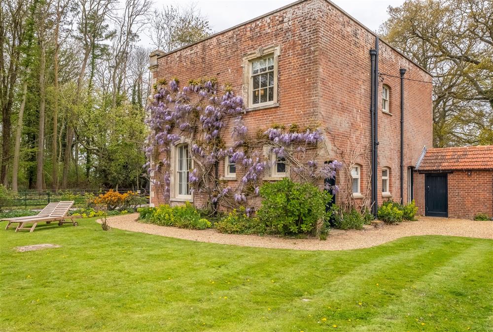 The outside of The Gatehouse with Wisteria growing up the brickwork at The Gate House, Aylsham near Norwich