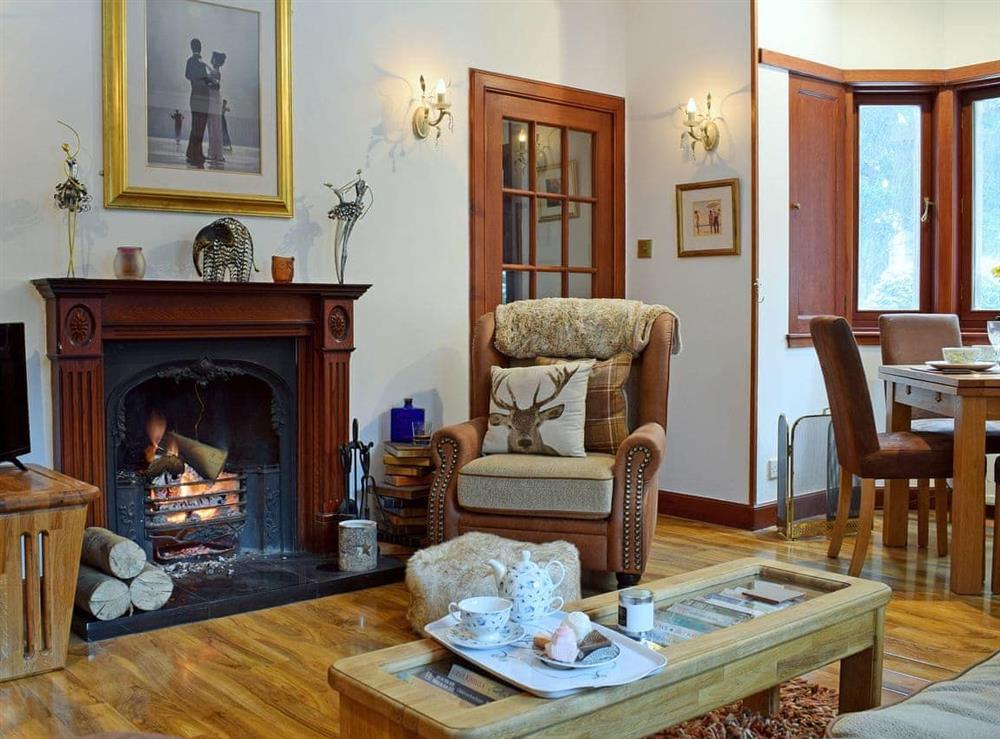 Warm and welcoming living/dining room with open fire at The Gate House in Markinch, near Glenrothes, Fife