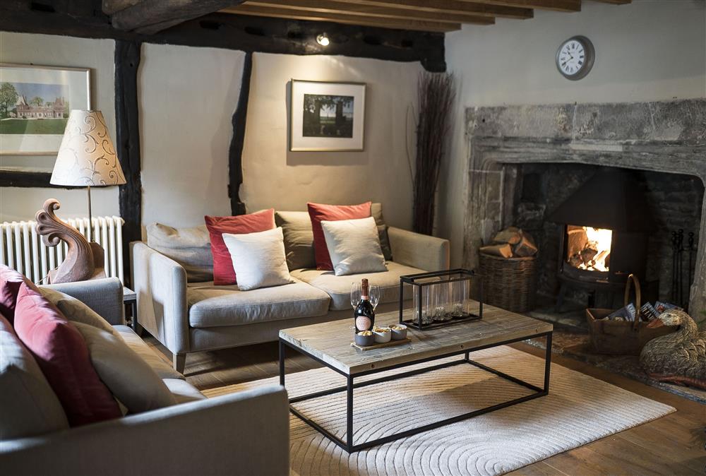 Sitting room with wood burning stove at The Gates, Castle Combe