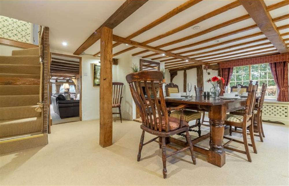 Dining room with stairs to first floor and doorway through to the sitting room at The Gildhall, Higham
