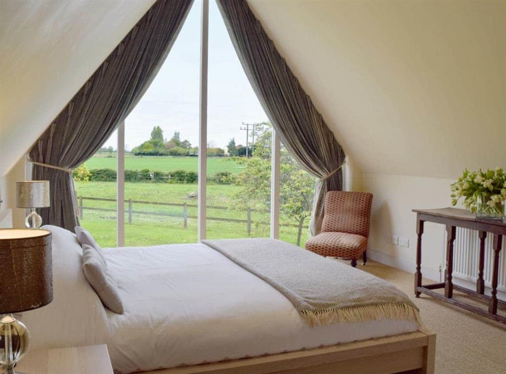 Double bedroom with stunning floor-to-ceiling window at The Glass Room in Ardleigh Heath, near Colchester, Essex